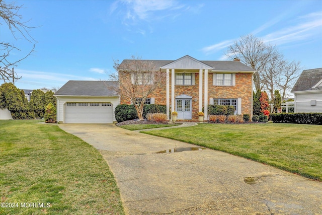 view of front of property featuring a garage and a front lawn