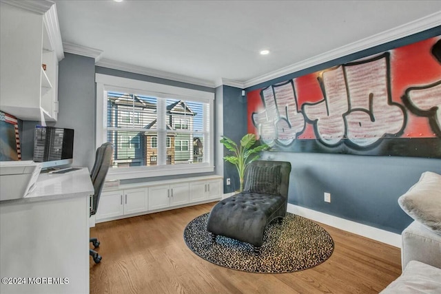 office area with light hardwood / wood-style floors and ornamental molding