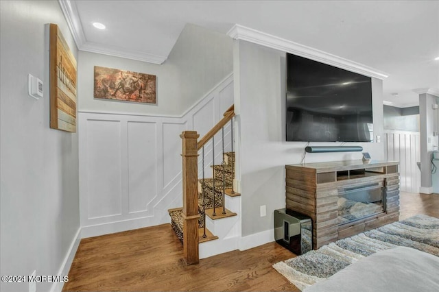 interior space featuring wood-type flooring and ornamental molding