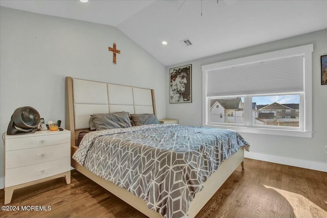 bedroom featuring hardwood / wood-style flooring and lofted ceiling