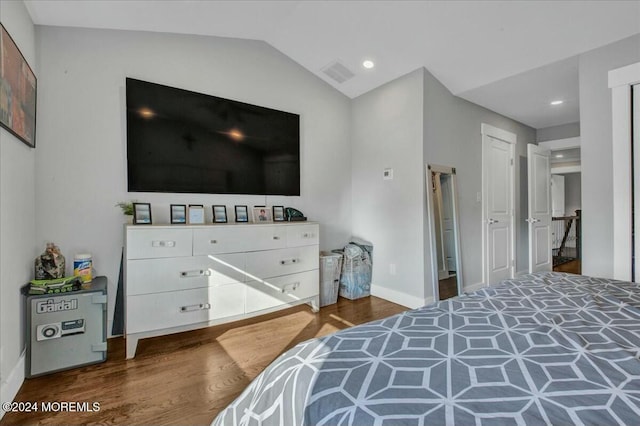 bedroom featuring dark wood-type flooring and lofted ceiling