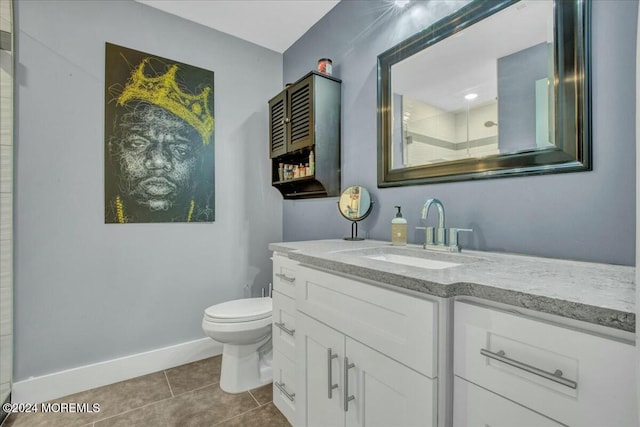 bathroom featuring tile patterned flooring, a shower, vanity, and toilet