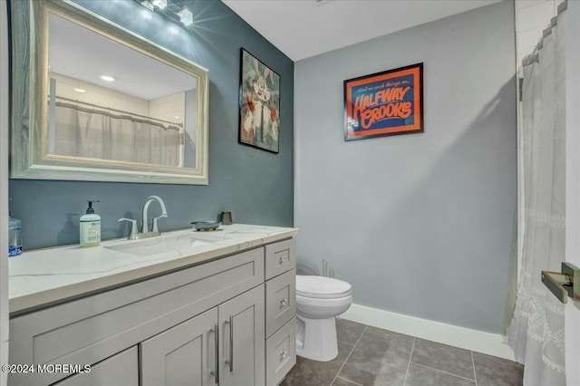 bathroom featuring tile patterned floors, vanity, and toilet