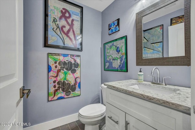 bathroom featuring tile patterned flooring, vanity, and toilet