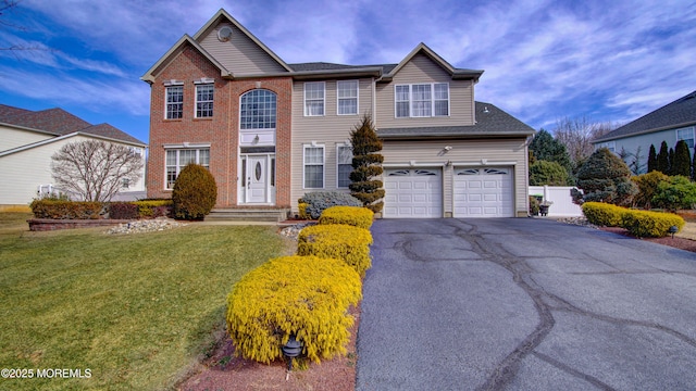 view of front of home featuring aphalt driveway, a front yard, brick siding, and an attached garage