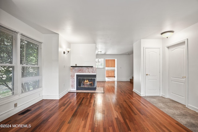 unfurnished living room with dark hardwood / wood-style flooring