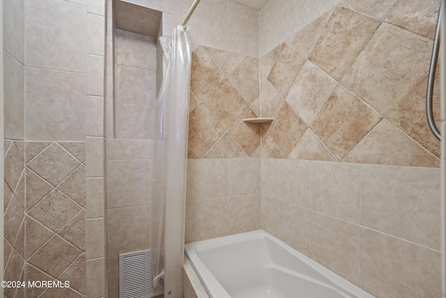 bathroom featuring shower / bath combo with shower curtain