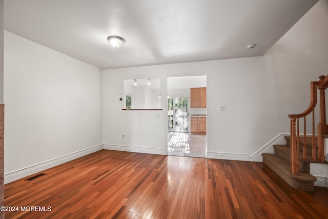 empty room featuring dark wood-type flooring