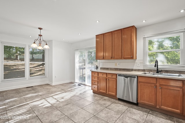 kitchen with sink, hanging light fixtures, stainless steel dishwasher, a chandelier, and light tile patterned floors