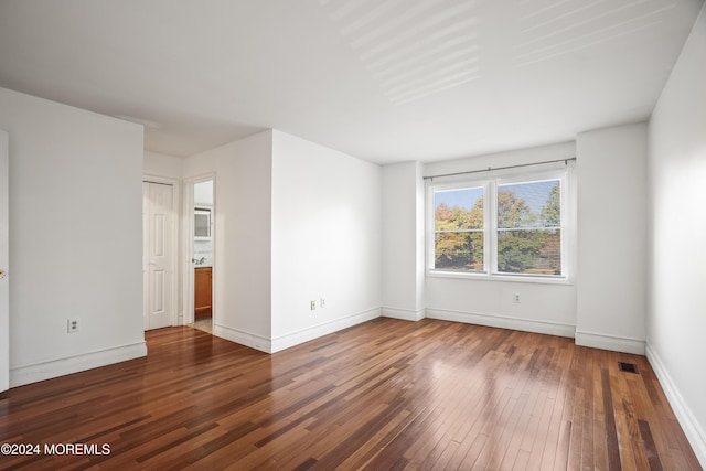 spare room featuring dark hardwood / wood-style floors