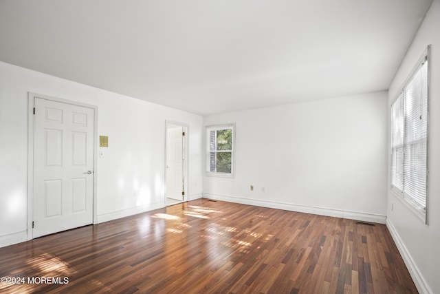 spare room with dark hardwood / wood-style flooring