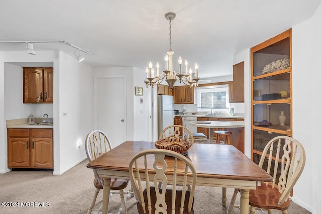 carpeted dining area with sink and an inviting chandelier