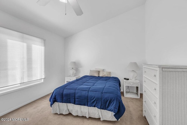 carpeted bedroom with ceiling fan and lofted ceiling