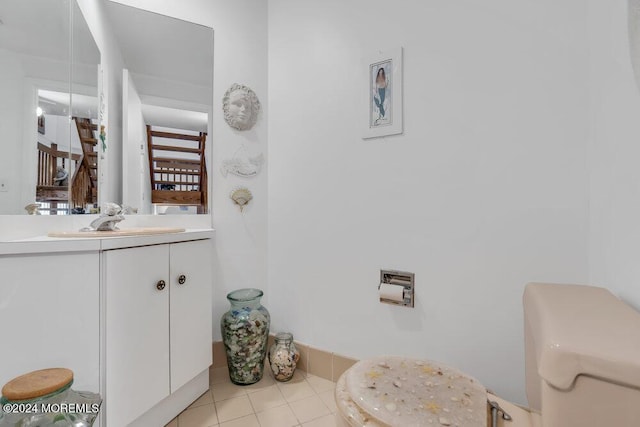 bathroom featuring tile patterned flooring, vanity, and toilet