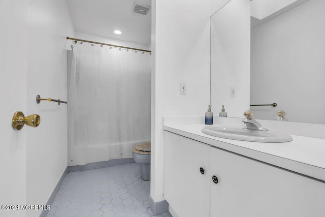 bathroom with a shower with curtain, tile patterned flooring, vanity, and toilet