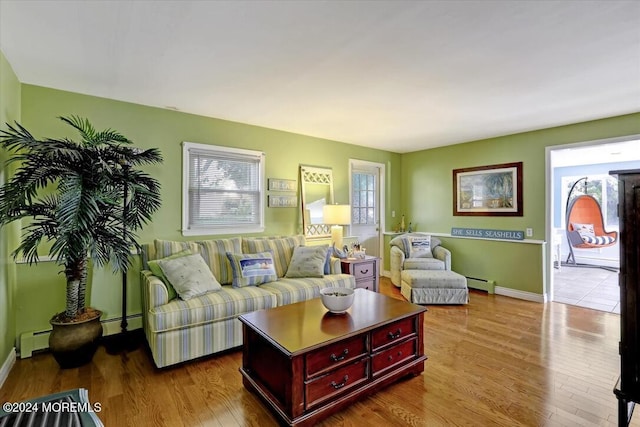 living room with a baseboard radiator and light wood-type flooring