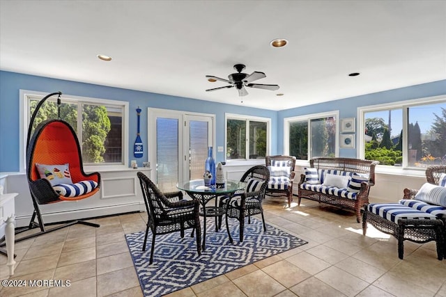 dining space with ceiling fan, light tile patterned flooring, and french doors