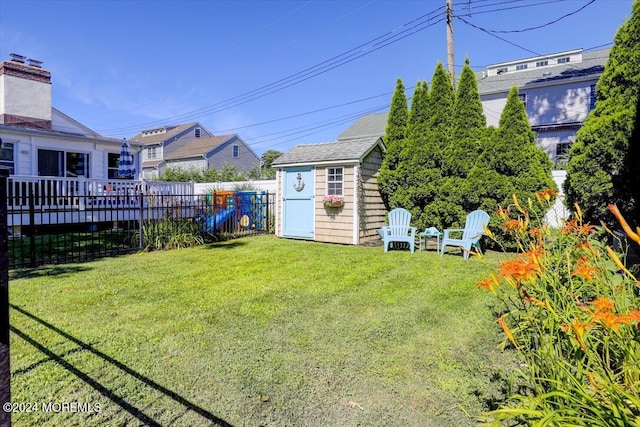 view of yard featuring a deck and a storage unit