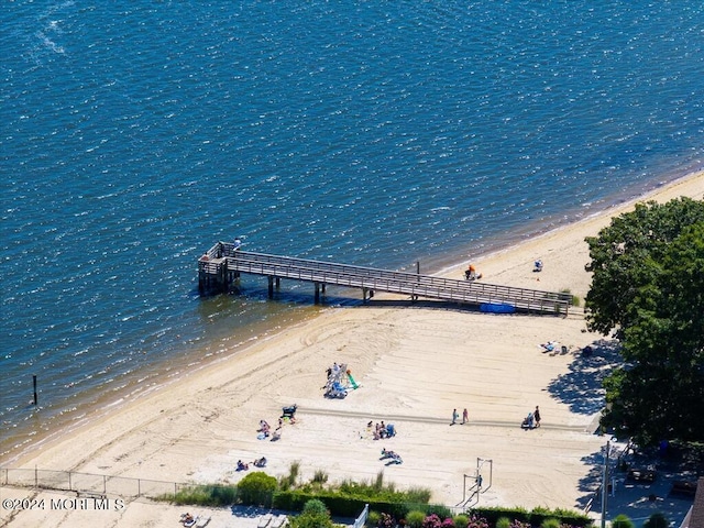 drone / aerial view featuring a water view and a beach view