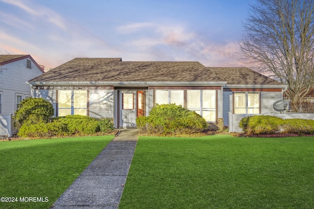 view of front of home with a lawn and cooling unit