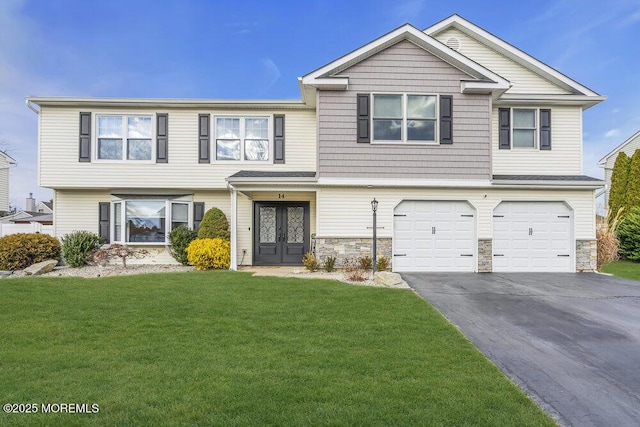 view of front of house with french doors, a garage, and a front lawn