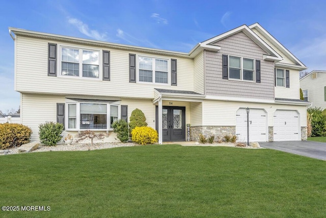 view of front facade featuring a front lawn, a garage, and french doors