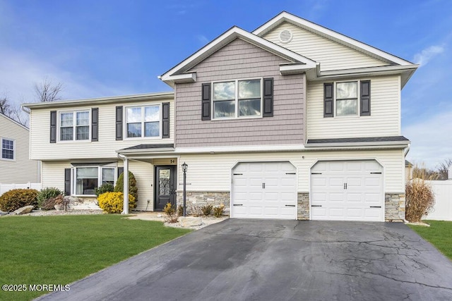 view of front of home with a garage and a front lawn