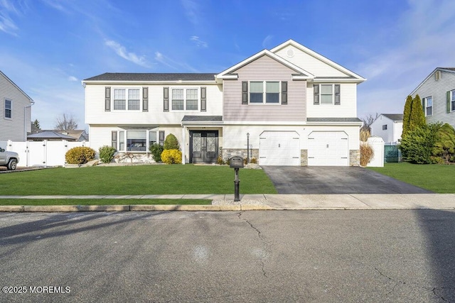 view of front of house with a garage and a front yard