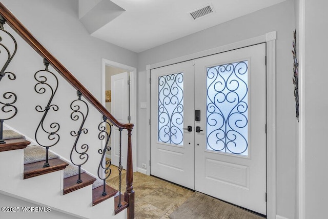 foyer with plenty of natural light and french doors