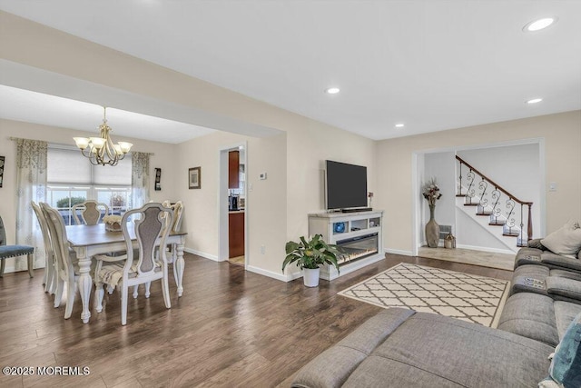 living room featuring dark hardwood / wood-style floors and an inviting chandelier