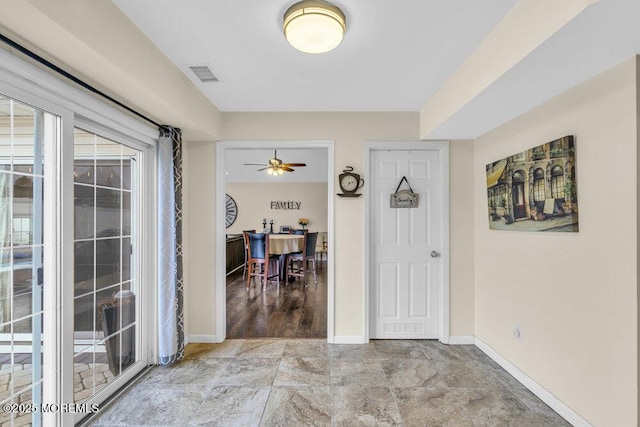 entrance foyer featuring ceiling fan