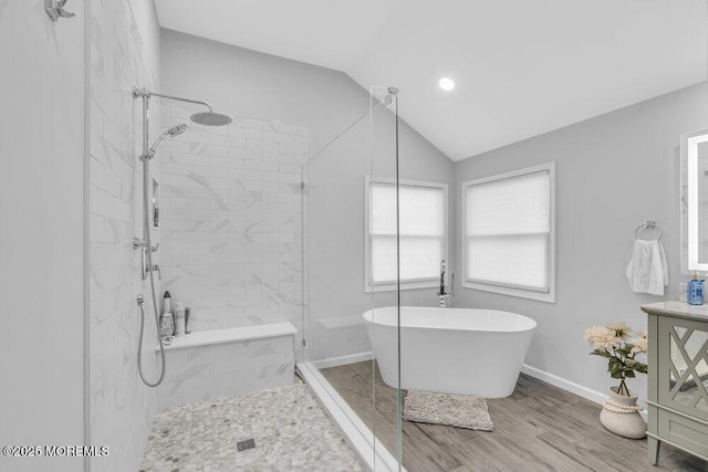 bathroom with wood-type flooring, separate shower and tub, and lofted ceiling