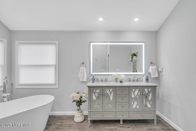 bathroom featuring vanity and a bath