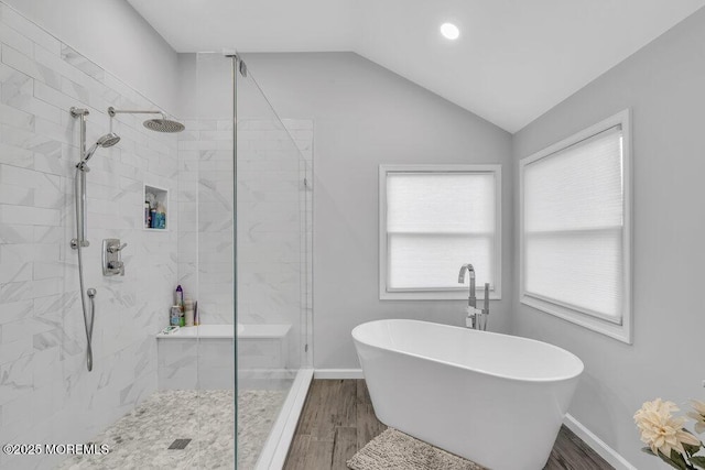 bathroom featuring hardwood / wood-style floors, separate shower and tub, and lofted ceiling