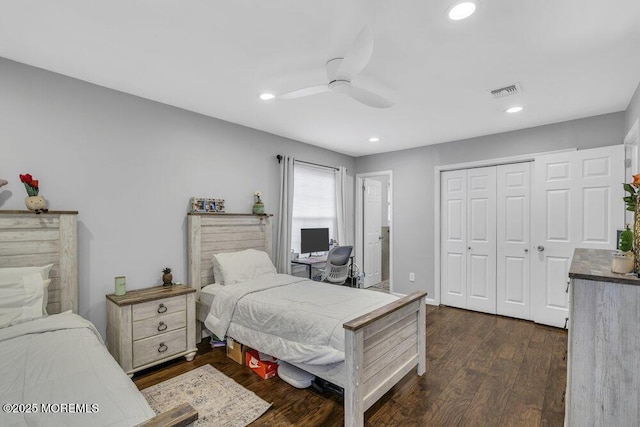 bedroom with dark hardwood / wood-style flooring, a closet, and ceiling fan