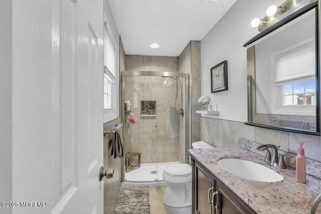 bathroom with tile patterned floors, vanity, toilet, and an enclosed shower