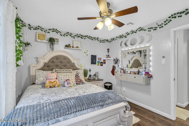 bedroom with ceiling fan and dark hardwood / wood-style flooring