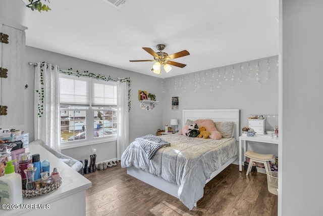 bedroom featuring ceiling fan and dark wood-type flooring