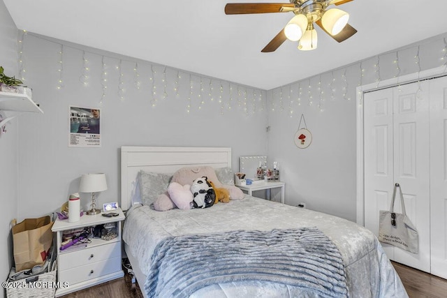 bedroom with ceiling fan, dark hardwood / wood-style flooring, and a closet