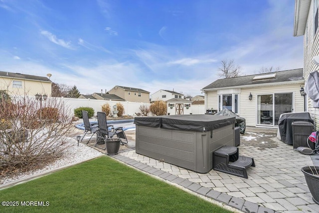 view of yard featuring an outbuilding, a patio, and a hot tub