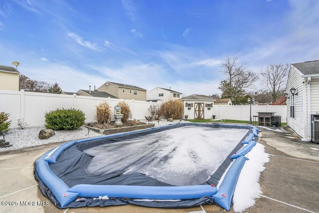 view of swimming pool featuring a storage shed