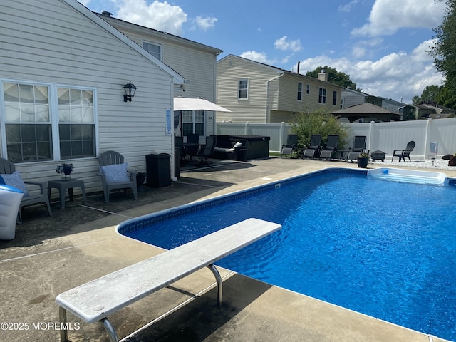 view of pool featuring a patio and a diving board