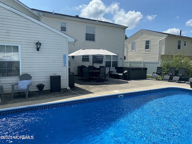 view of swimming pool with area for grilling, a patio, and a hot tub