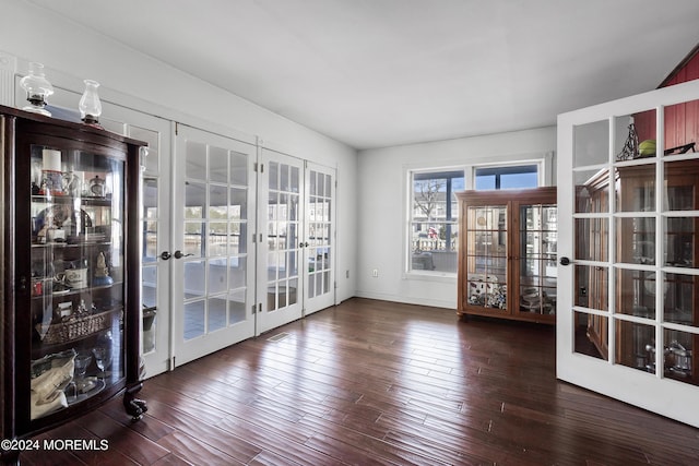 empty room featuring dark hardwood / wood-style floors and french doors