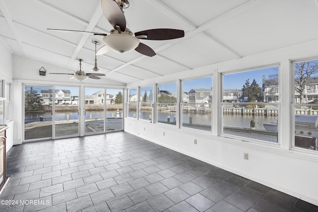 unfurnished sunroom with lofted ceiling with beams, ceiling fan, a water view, and coffered ceiling