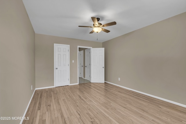 unfurnished bedroom with ceiling fan and light wood-type flooring