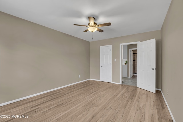 unfurnished room with ceiling fan and light wood-type flooring