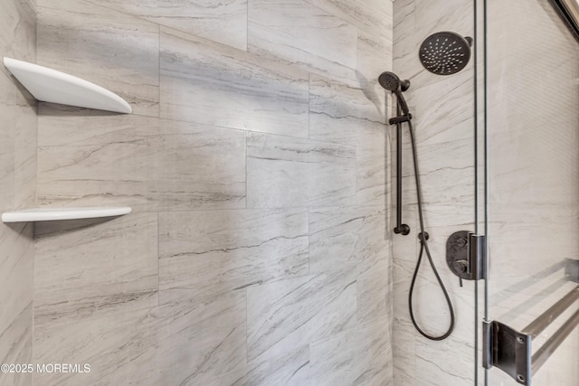 interior details featuring tiled shower