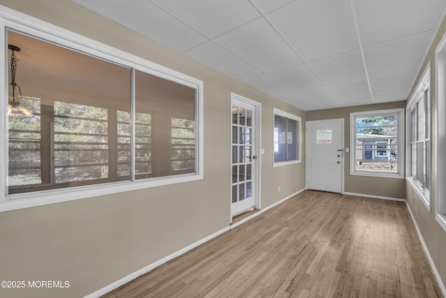 unfurnished sunroom with a paneled ceiling