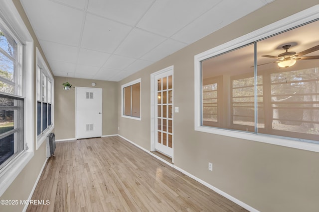 unfurnished sunroom featuring a paneled ceiling and ceiling fan